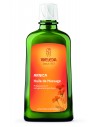 WELEDA Huile de Massage à l'Arnica - Flacon vert bouteille, étiquette orange avec des fleurs et bouchon blanc